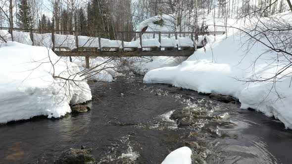 Small wooden bridge over stream.