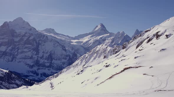 Aerial drone footage of winter landscape in the Swiss alps. Wetterhorn, Schreckhorn and Finsteraarho