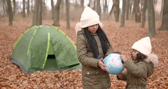 Black Race Kids Holding a Globe in an Autumn Forest