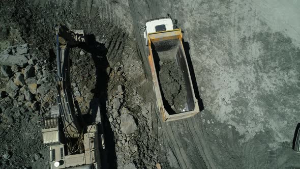 Excavator Fills Dump Truck