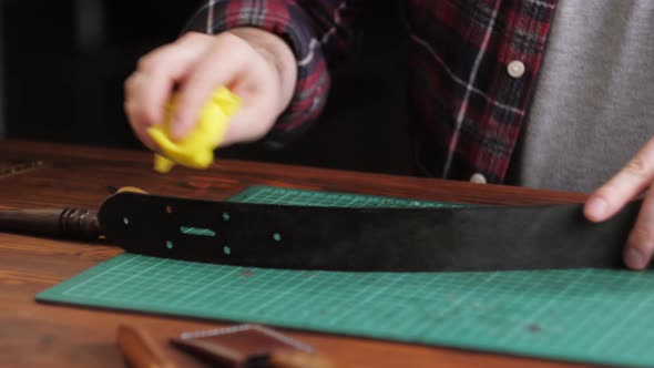 Man Tailor Cutting Artificial Leather with Ruler Closeup