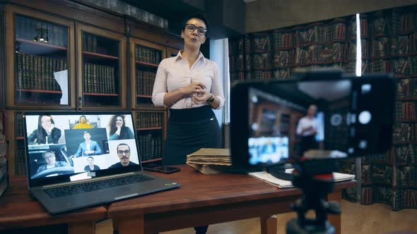 A Woman Is Carrying Out a Video Lesson in the Library