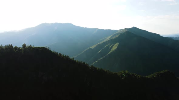 Silhouette of a Mountain Against a White Sky