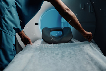 Radiographer Preparing CT Scanner Bed
