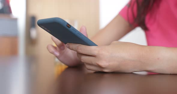 Close up Of Woman Use of Mobile Phone at Home