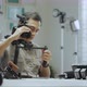An Asian man is trying on camera rigs - VideoHive Item for Sale