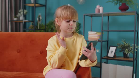 Girl Kid Enjoying Conversation on Mobile Phone with Friend Relaxing Sitting on Sofa at Home Alone