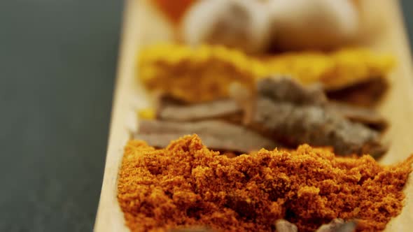 Various spices on wooden tray 4k