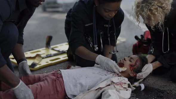 Ambulance Crew Examining Little Girl After Car Accident