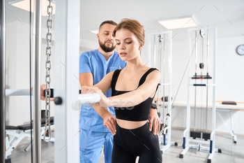 Female patient is engaged in a kinesiology clinic