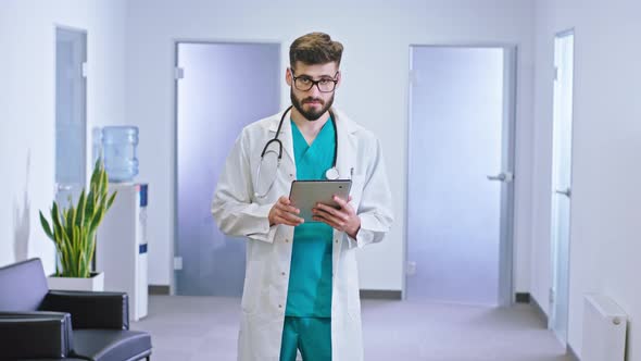 Charismatic Man Doctor in Front of the Camera in