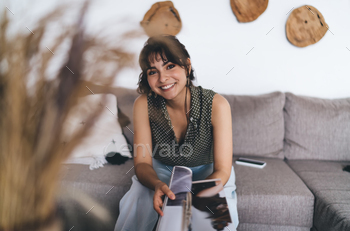 Young female reading journal and smiling