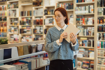 Woman in library holding a book