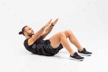 Man Performing Crunch Exercise on Floor On Grey Background