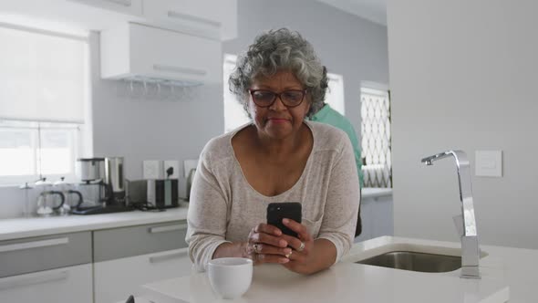 A senior african american couple spending time together at home social distancing in quarantine.