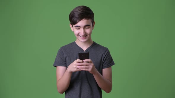 Young Handsome Iranian Teenage Boy Against Green Background