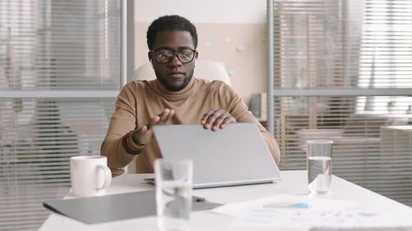 African Businessman Finishing Working on Computer