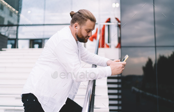 Concentrated man chatting on smartphone