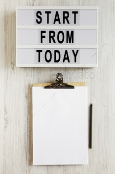 'Start from today' words on a lightbox, clipboard with blank sheet of paper.