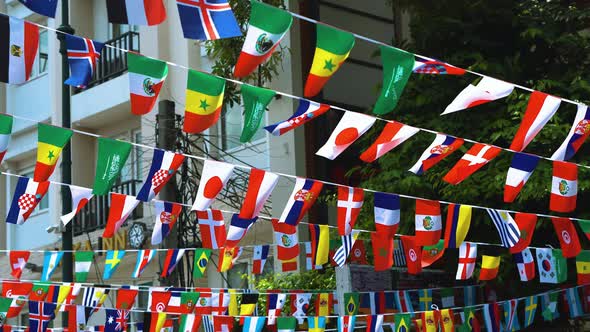 Flags of Different Countries Hang on City Streets