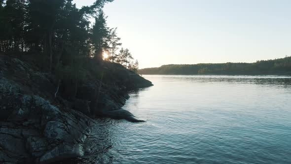 Aerial Motion Above River Past Islands with Forest at Sunset