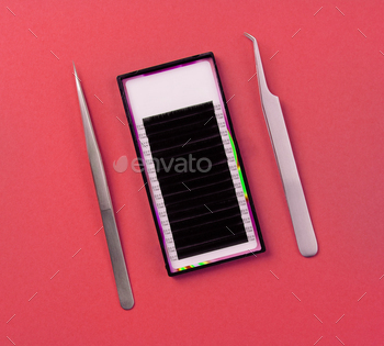 Eyelash extension supplies on red background