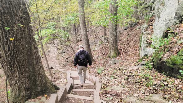 Hikers descend a path from the top of a trail in the Blue Ridge Mountains of Virginia on rustic step