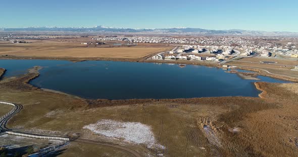 Mountain vistas with homes and a lake in Northern Colorado. Drone 4k 60fps.