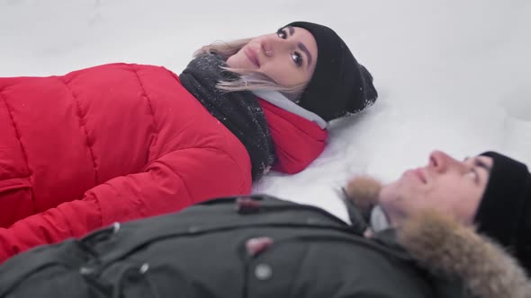 Young Couple Lying in Snow