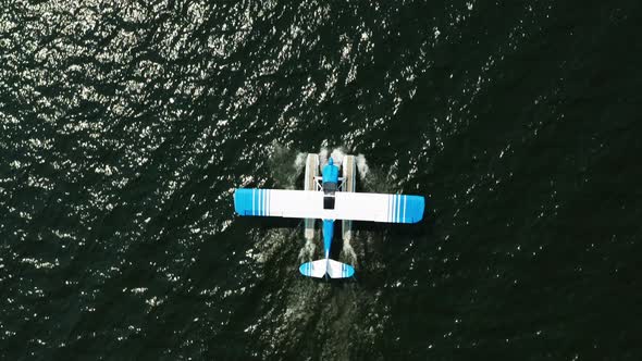 Aerial top down, seaplane floating on ocean lake water