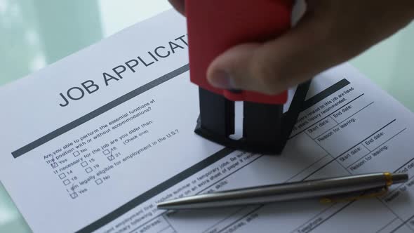 Job Application Document Pending, Hand Stamping Seal on Official Paper, Hiring