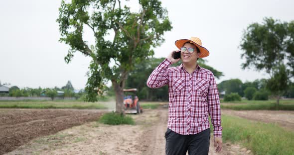 Farmer walking talking on smartphone