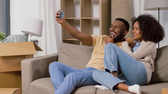 Happy Couple Moving To New Home and Taking Selfie