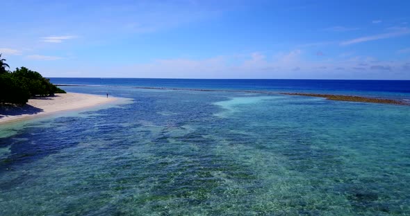 Wide birds eye copy space shot of a sunshine white sandy paradise beach and blue ocean background in