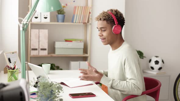 Young Hispanic Latin Man Studying Online in His Room