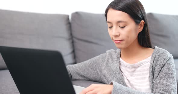 Woman working on laptop computer at home