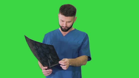 Doctor Having a Look at Mri Brain Scan on a Green Screen, Chroma Key.