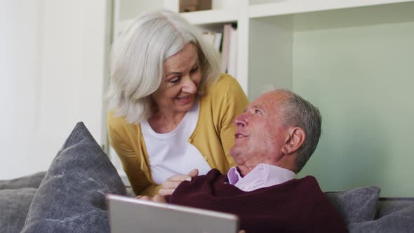 Senior caucasian couple using laptop computer together