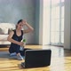 Lady with Water Mops Brow Resting After Training Near Laptop - VideoHive Item for Sale