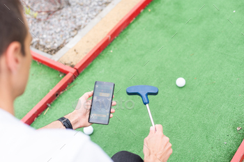 Touch screen in hand, tablet on golf club. smartphone with a sports betting application