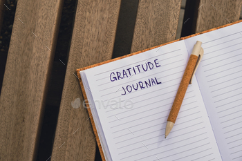 Writing Gratitude Journal on wooden bench. Today I am grateful for. Self discovery journal, self
