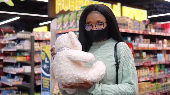 Girl in a Mask Has Shopping in the Supermarket