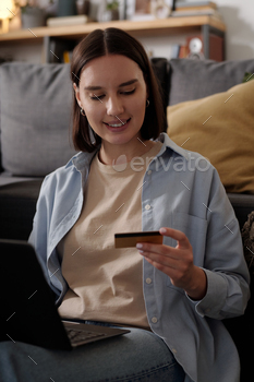 Young smiling woman with credit card