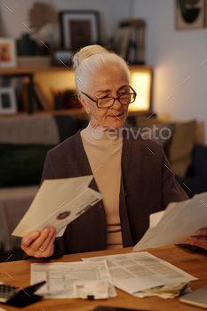 Elderly woman looking through post