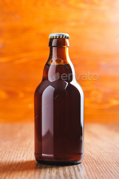Bottle of beer on wooden table.