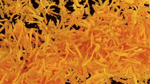 Super Slow Motion Detail Shot of Flying Grated Cheddar Cheese at 1000 Fps