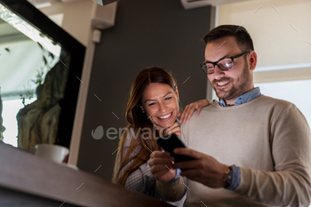 Couple in a restaurant using a smartphone