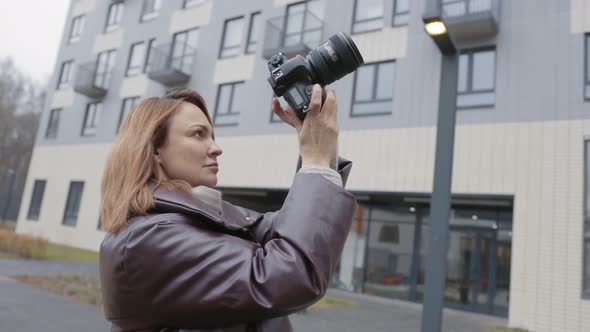 Woman takes photo on professional camera