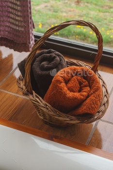 Orange and brown towels in a basket