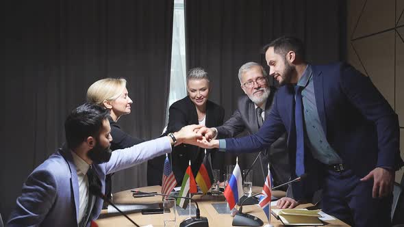 Interracial Group of Executives Holdng Hands Together